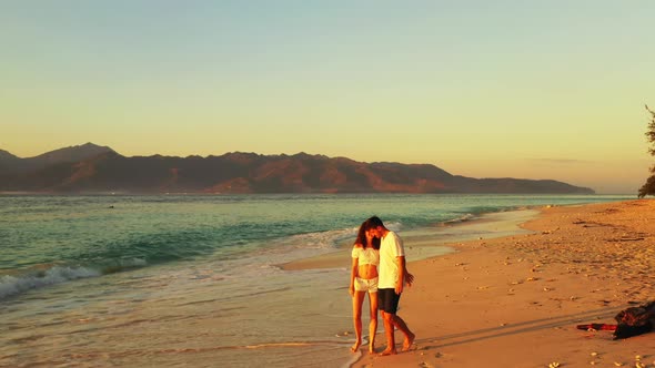 Fun boy and girl after marriage in love enjoy life on beach on sunny white sandy 4K background