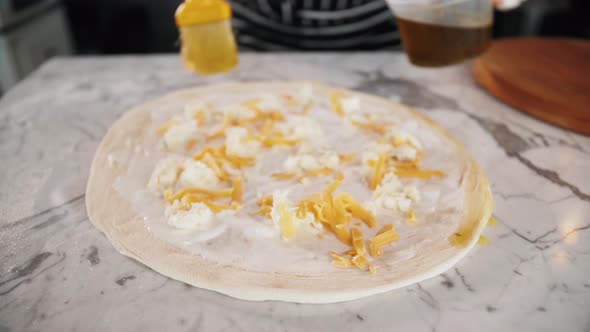 Chef Spreading Sour Cream and Cheese Over Pizza Dough Cooking Italian Pizza