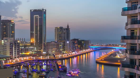 An Aerial View of Dubai Marina Towers in Dubai Day to Night Timelapse