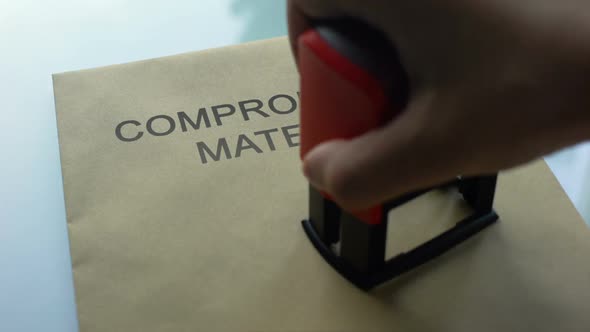 Compromising Material Private, Hand Stamping Seal on Folder With Documents