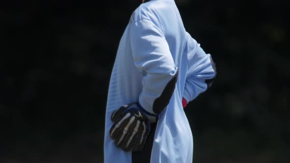 Young boy playing goalie in a youth soccer league game.