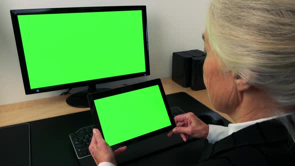 Old Caucasian Woman Works on Computer and Tablet in Home - Green Screen