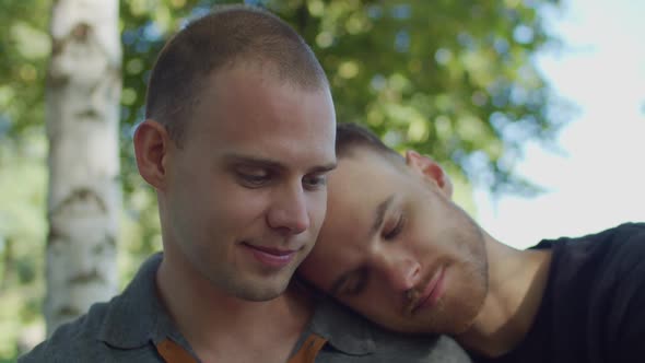 Handsome Gay Leaning Head on Boyfriend's Shoulder