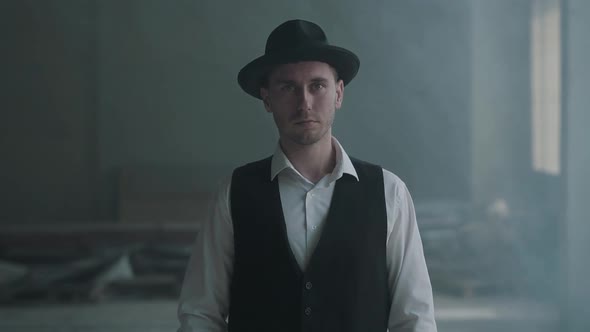 Portrait Handsome Confident Man in a Hat Looking To the Camera in an Abandoned Building. Boss of the