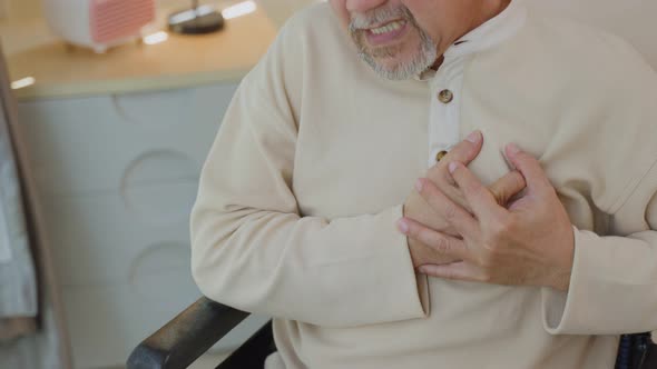Close up of Senior Elderly disabled man on wheelchair with chest pain suffer from heart attack.