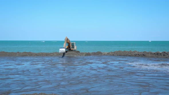 Timelapse of the Excavator Working in Front of the Sea