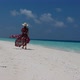 Walking woman on an empty beach - VideoHive Item for Sale