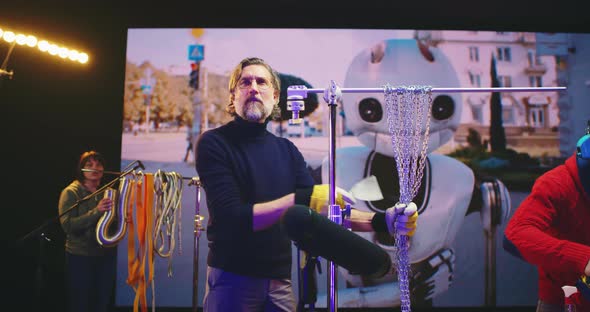 People Creating Soundtrack for 3D Cartoon Abound Robot