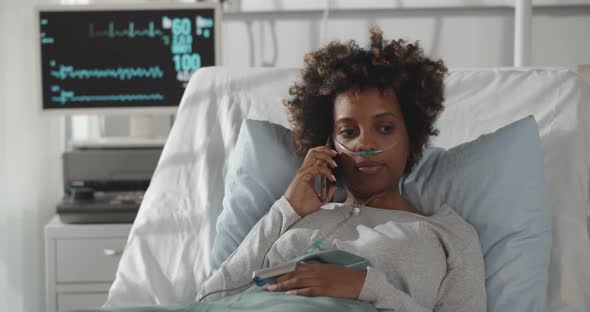 African Lady Patient Having Phone Conversation in Hospital Room