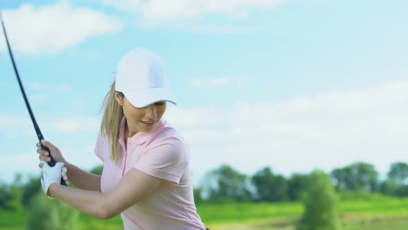 Smiling Girl Making Half-Swing and Hitting Ball Into Green, Making Yes Gesture