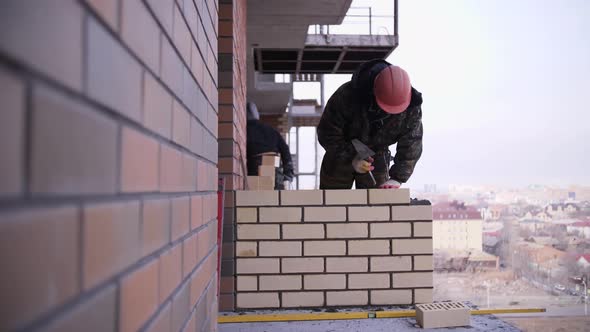 footage of builder lays bricks