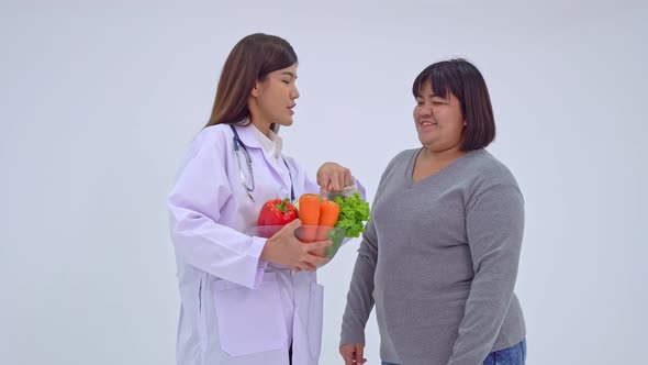 Doctor or nutritionist holding fresh fruit and introduce nutrition to patients