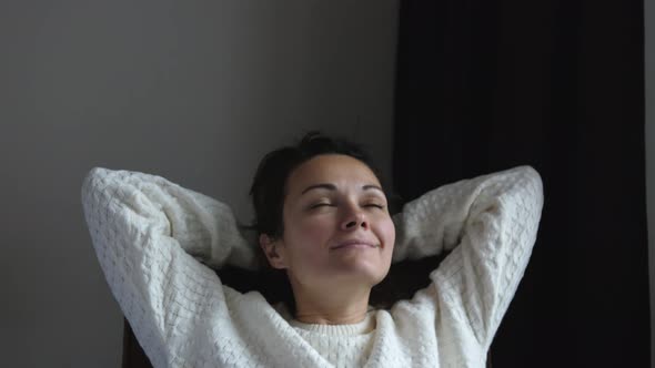 Calm Young Pretty Woman Relaxing in Armchair