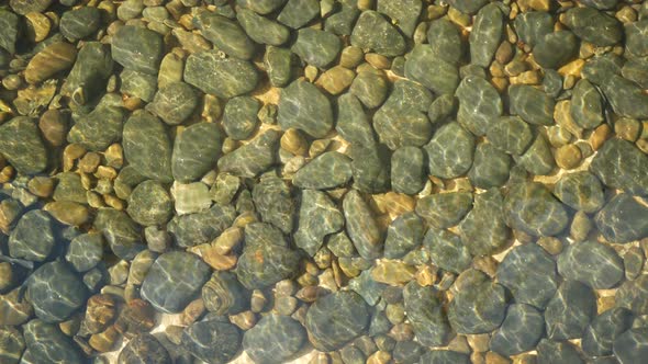 Clean Round Stones Clearly Visible in Crystal Water. From Above Clean Crystal Water and Round Grey