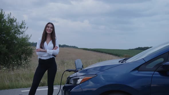 Slow Motion of a Woman That Stands Near Her Blue Car