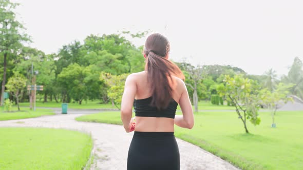 Asian young beautiful sport athlete woman exercise by running outdoor on street in public park.