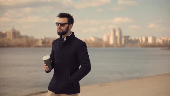 Man Drink Coffee And Relaxing After Work. Italian Man Looking At River. Businessman Drinking Tea.