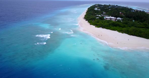 Tropical aerial tourism shot of a white sandy paradise beach and turquoise sea background in hi res 