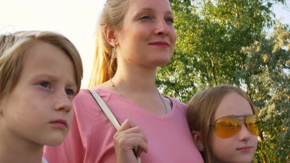 Beautiful Family with Blue Eyes and Blond Hair are Smiling with a Happy Smile