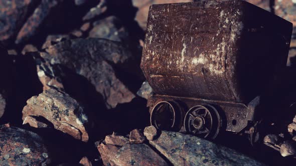 Abandoned Rusty Mine Cart on Rocks alt