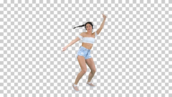 Caucasian Female Model in Headphones Jumping Expressing Happy