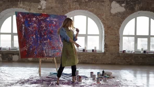 Woman Dancing in Art Studio in Slowmo Pretending to Sing to Microphone