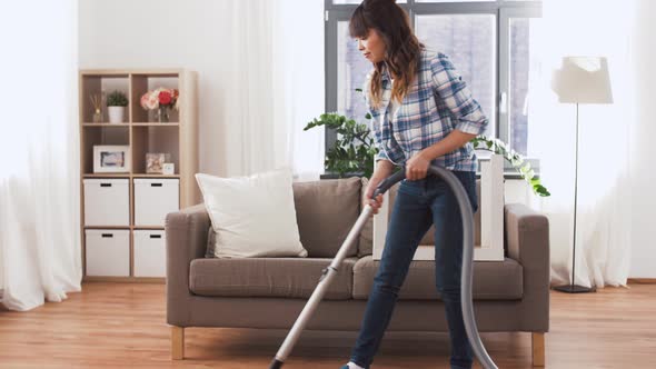 Asian Woman with Vacuum Cleaner at Home