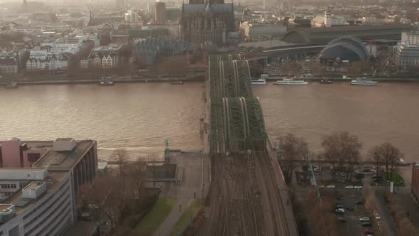 AERIAL: View Over Cologne Hohenzollern Bridge and Cathedral in Beautiful Hazy Sunlight 