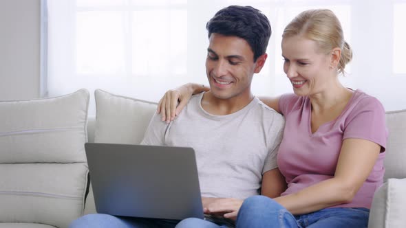 Couple Using Laptop in a Conversation