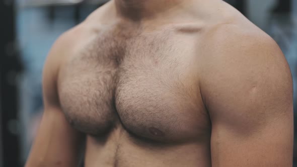 A Man Moves His Strong and Muscular Chest