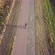 Top aerial view of a guy riding A Mountain Bike In The Road At Sunset During A Cold Autum - VideoHive Item for Sale
