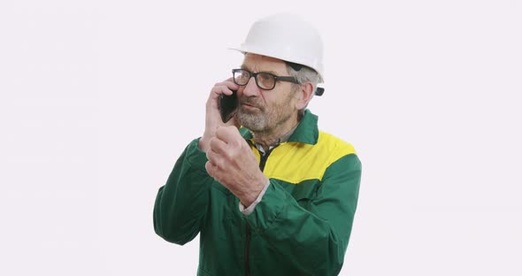 Portrait of Old Senior Business Man in Suit and Helmet Isolated Over White Background Talking on the