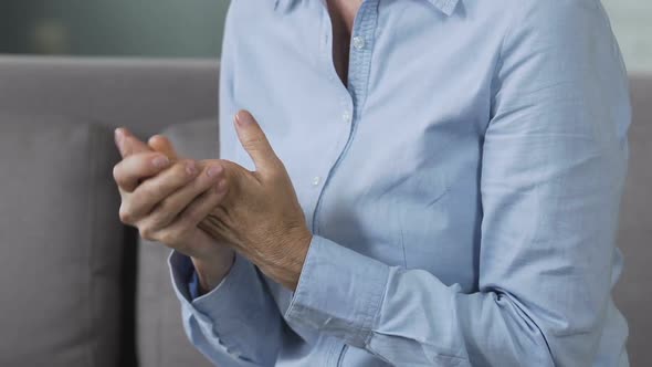 Nervous lady rubbing hands, visiting doctor to discuss psychological problems