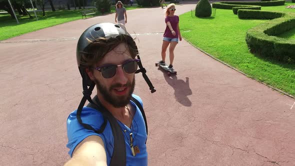 Close up of a man skateboarding with friends