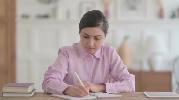 Indian Woman Writing on Paper in Office