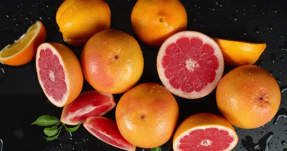 Fresh Juicy Grapefruits with Leaves Slowly Rotate. 