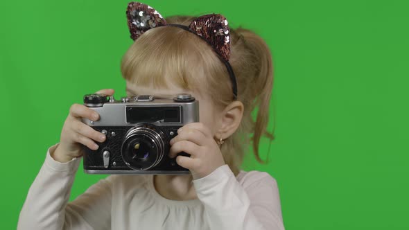 Girl in Cat Headband Taking Pictures on an Old Retro Photo Camera