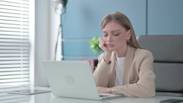 Tired Woman Sleeping While Sitting in Office