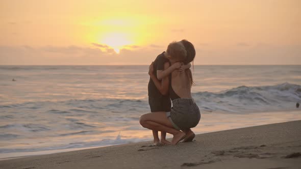 Mother Embracing Son at Beach