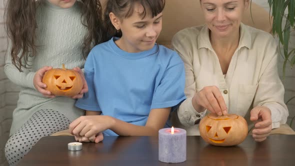 Halloween. Family with a carved pumpkin. 