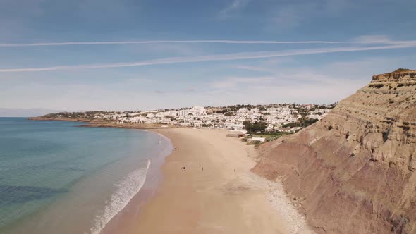 Praia da Luz beach in Algarve.  Empty sandy beach and Atlantic Ocean. Aerial forward