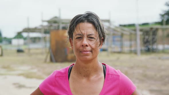 Caucasian woman looking at camera at boot camp