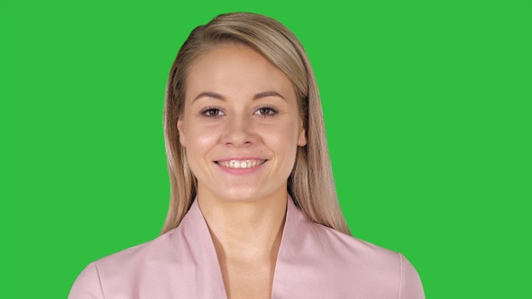 Young beautiful stylish woman walking on a Green Screen