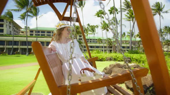 Relaxed Woman Swinging in Slow Motion Girl Relaxing in Garden Island Resort RED