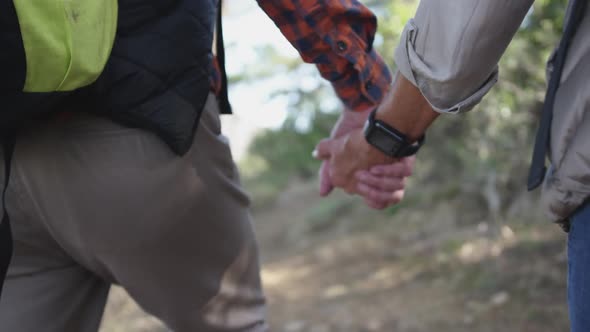 Senior couple holding hands in forest