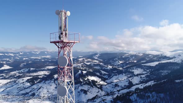 Flying Over Radio Communications Tower, Mountain Snow Covered Winter Landscape