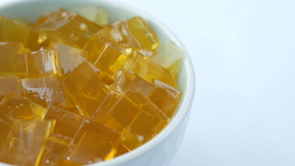 Close Up of Yellow Jelly in a Bowl on White Background