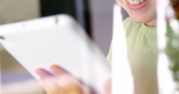 Boy using digital tablet in kitchen