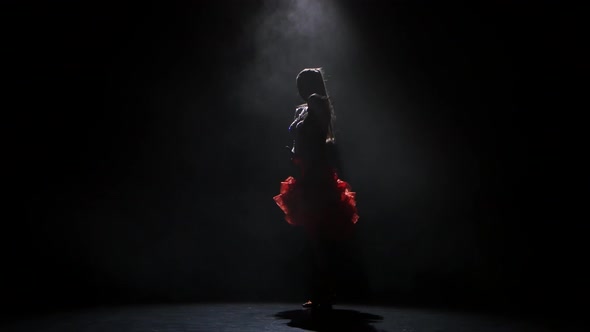 Beautiful Girl Dancing Samba in the Studio on a Dark Background, Smoke