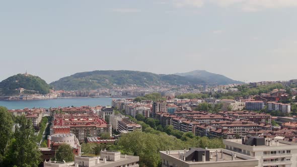 Majestic rooftops of San Sebastian city with bay view, aerial cinematic view